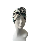 Turban with black and white pattern on a mannequin head against a white background