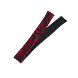 A pair of athletic compression sleeves, one featuring a red and black wavy pattern and the other solid black, displayed on a clean white background.