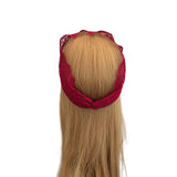 Blonde hair extension with red lace clip on a white background