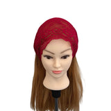 Red lace headscarf on a mannequin head with brown hair against a white background