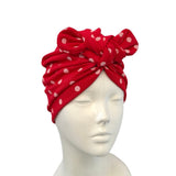 Red polka dot headscarf on a mannequin head against a white background