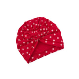Red headband with white polka dots on a white background