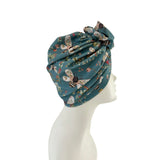 Floral patterned headscarf on a mannequin head against a white background