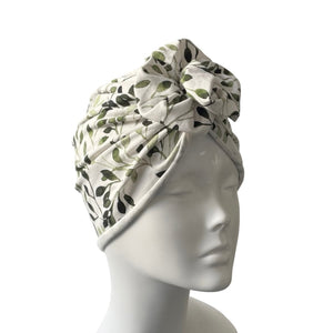Floral patterned headscarf on a mannequin head against a white background
