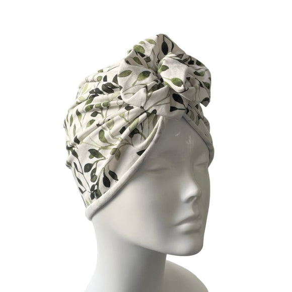 Floral patterned headscarf on a mannequin head against a white background