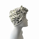Headscarf with leaf pattern on a mannequin head against a white background