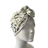 Floral patterned headscarf on a mannequin head against a white background