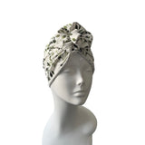 Floral patterned headscarf on a mannequin head against a white background