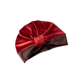 Red and brown turban with a bow on a white background