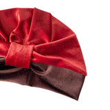 Red and brown velvet headband with a bow on a white background
