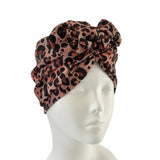 Leopard print headscarf on a mannequin head against a white background