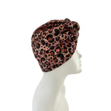 Leopard print headscarf on a mannequin head against a white background