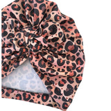 Leopard print headscarf with a knot on a white background