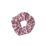 Pink leopard print scrunchie on a white background