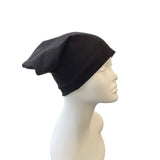 Black beanie on a mannequin head against a white background