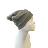 khaki beanie on a mannequin head against a white background