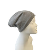 Gray beanie on a mannequin head against a white background