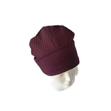 Maroon beanie on a mannequin head against a white background