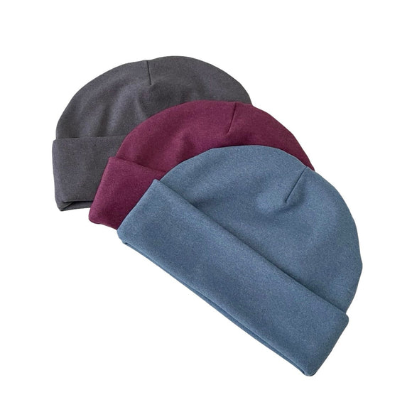 Three beanies in gray, maroon, and blue on a white background