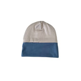 Two-tone beanie with beige top and blue bottom on a white background