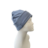 Blue beanie on a mannequin head against a white background