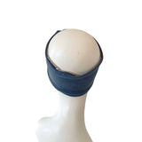 Blue headband on a mannequin head against a white background