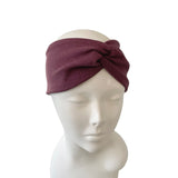 Mauve headband on a mannequin head against a white background