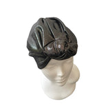 Black glittery head wrap on a mannequin head against a white background