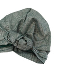 Green knotted headband on a white background