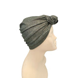 Gray knit turban on a mannequin head against a white background