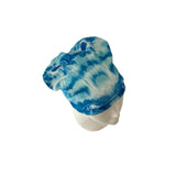 Blue and white tie-dye beanie on a mannequin head against a white background