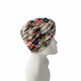 Multicolored headscarf on a mannequin head against a white background