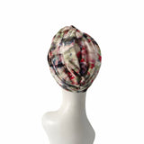 Plaid patterned headscarf on a mannequin head against a white background