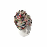 Colorful headscarf on a mannequin head against a white background