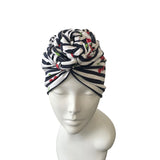 Striped headscarf with cherry pattern on a mannequin head against a white background