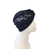 Navy blue headscarf with lace details on a mannequin head against a white background