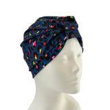 Colorful patterned headscarf on a mannequin head against a white background