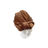 Brown turban on a mannequin head against a white background