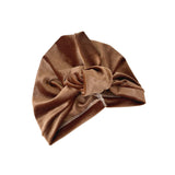 Brown velvet turban with a bow on a white background