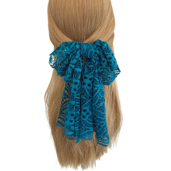 Blue lace hair bow on a white background