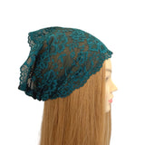 Teal lace headscarf on a mannequin head with long blonde hair against a white background