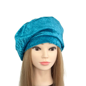 Blue turban on a mannequin head with long hair against a white background