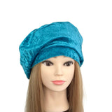 Blue turban on a mannequin head with long hair against a white background