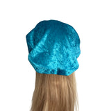 Blue satin hair bonnet on a mannequin head with blonde hair against a white background