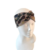 Leopard print headband on a mannequin head against a white background