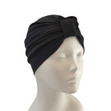 Black turban on a mannequin head against a white background
