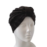 Black velvet turban on a mannequin head against a white background ireland