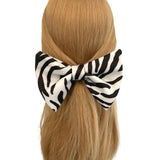 Zebra print hair scrunchie on a mannequin head with blonde hair against a white background