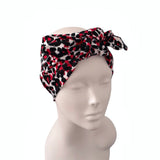 A black, red, and white patterned headwrap headband styled on a white mannequin head against a plain white background.