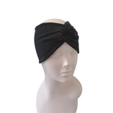 Black headband on a mannequin head against a white background